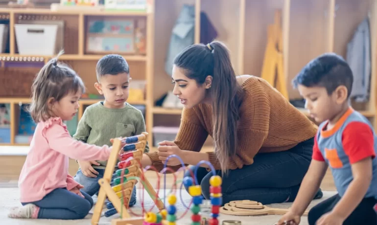Happy children exploring sensory wooden toys at the best school for toddlers in dehradun