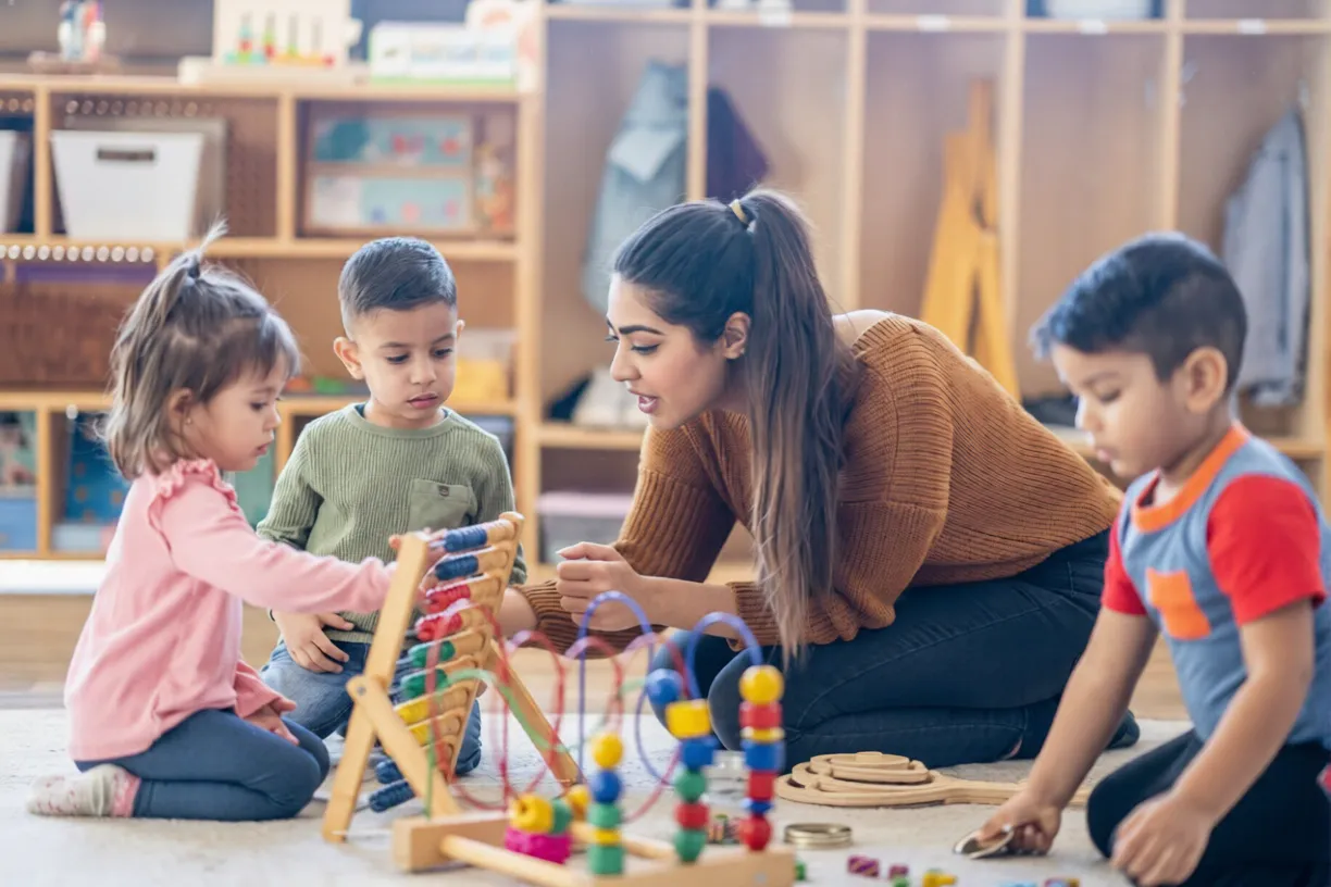 Happy children exploring sensory wooden toys at the best school for toddlers in dehradun